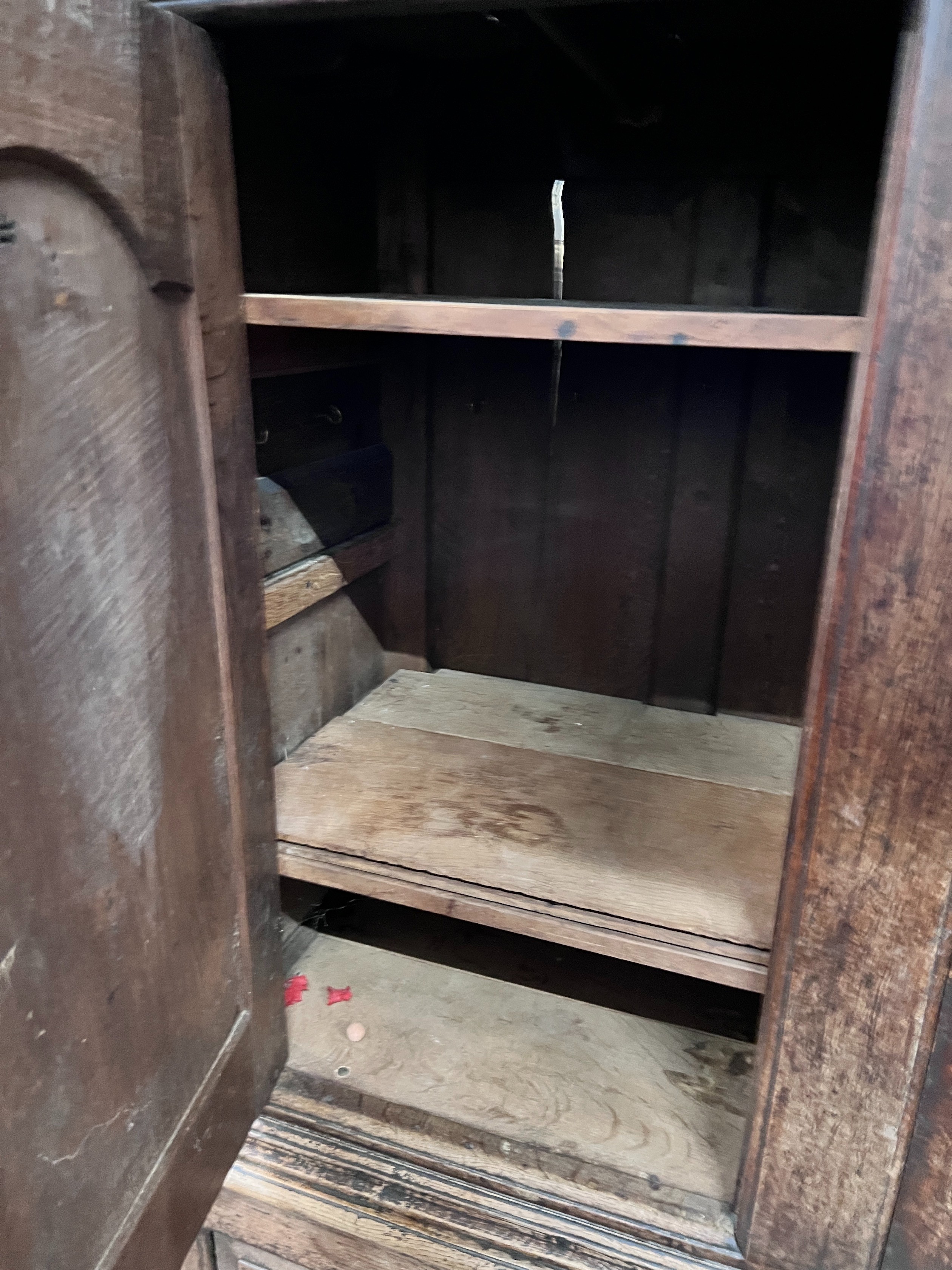 An early 18th century oak press cupboard two panelled doors and panelled base, width 127cm, depth 54cm, height 174cm *Please note the sale commences at 9am.
